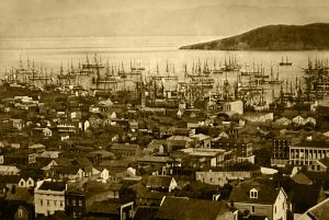 Houses in the foreground with harbor, ships, and Berkeley Hills, in the background