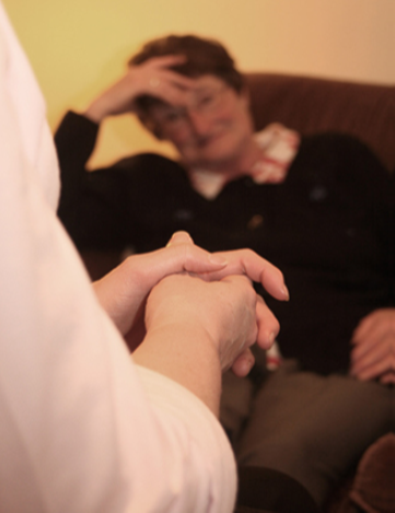 A photograph depicting a woman in a therapy session with her therapist is shown.