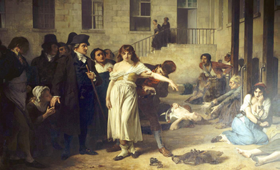 A painting, set inside an asylum, depicts a person removing the chains from a patient. There are several other people in the scene, but the focus is on these two characters.