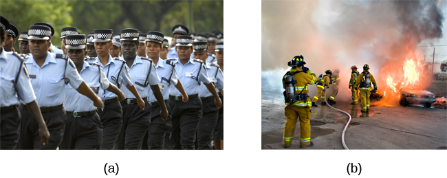 Photograph A shows uniformed police officers marching with synchronized arms swinging. Photograph B shows firefighters fighting a fire.