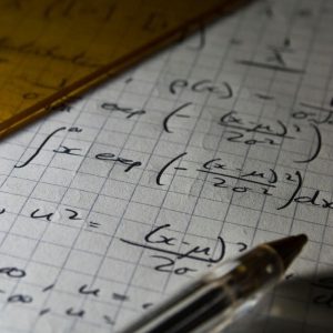 Image of math formulas written on a grid paper.