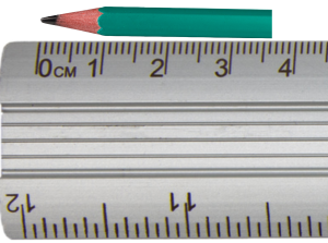 Pencil lying against rule with tip at 0 cm and end at 6 units past 3 cm
