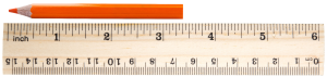 Pencil sitting next to a ruler. One end is at 0 inches the other end is 6 parts past 3. Each inch is plit into 16 equal parts.