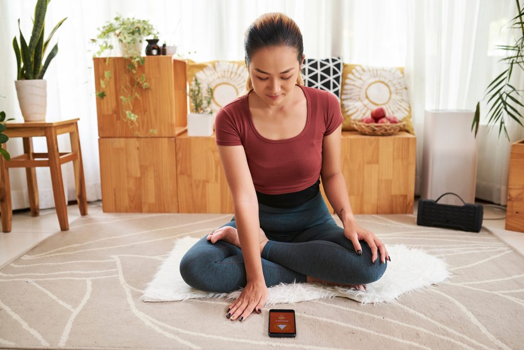 Woman setting app for meditation