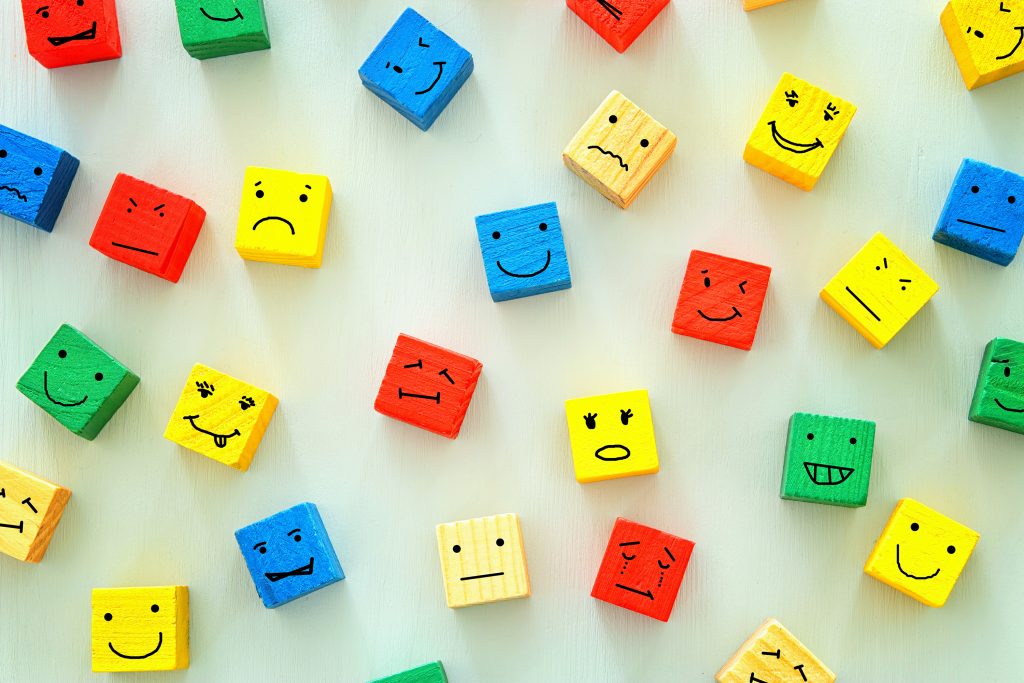 Different emotions drawn on colorful cubes