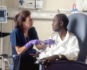 Nurse administering medication to patient