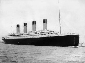 A black and white image of the Titanic floating on the ocean.