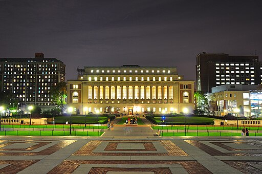 An illuminated Butler Library glows in the night.