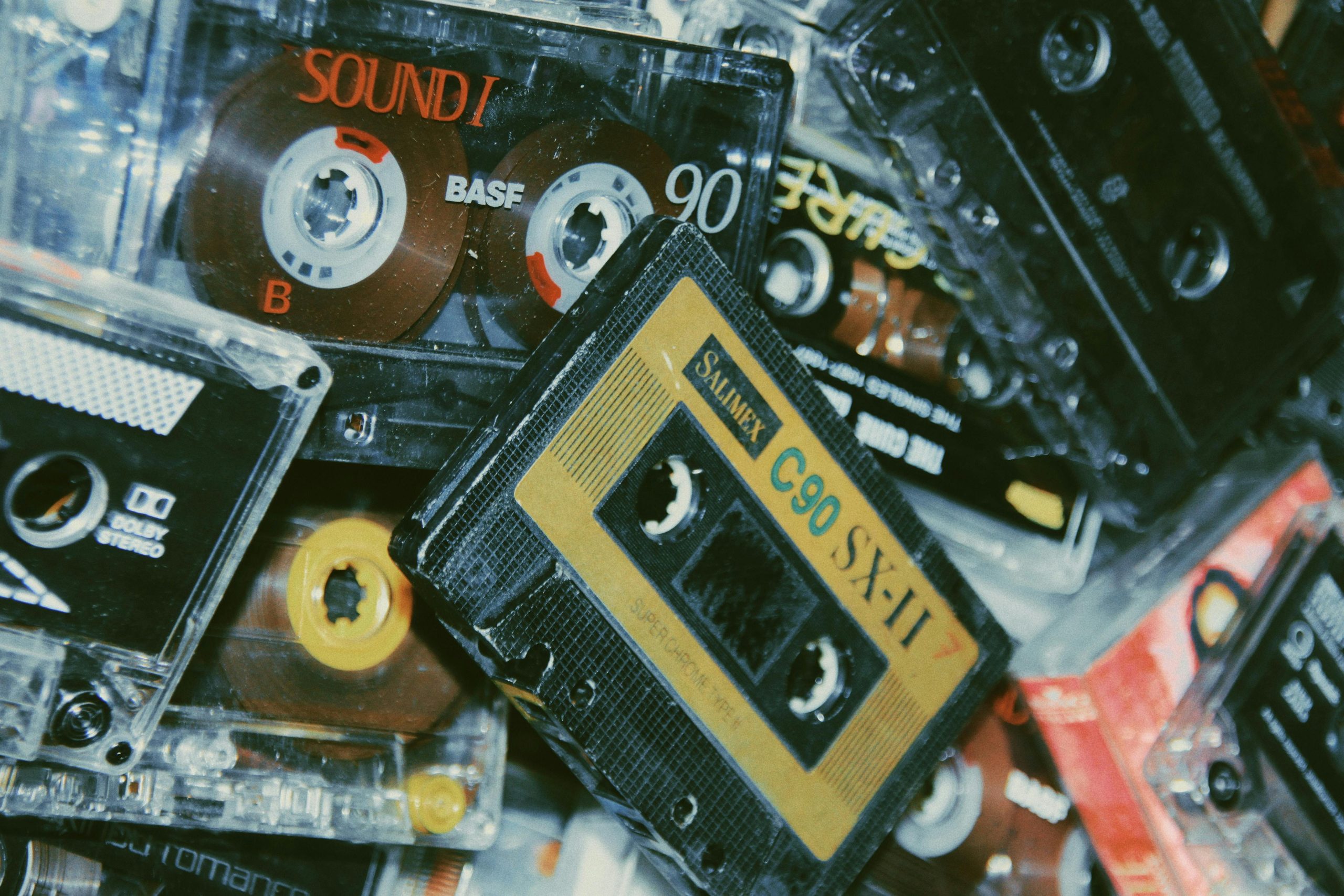 An image of a pile of vintage cassette tapes.