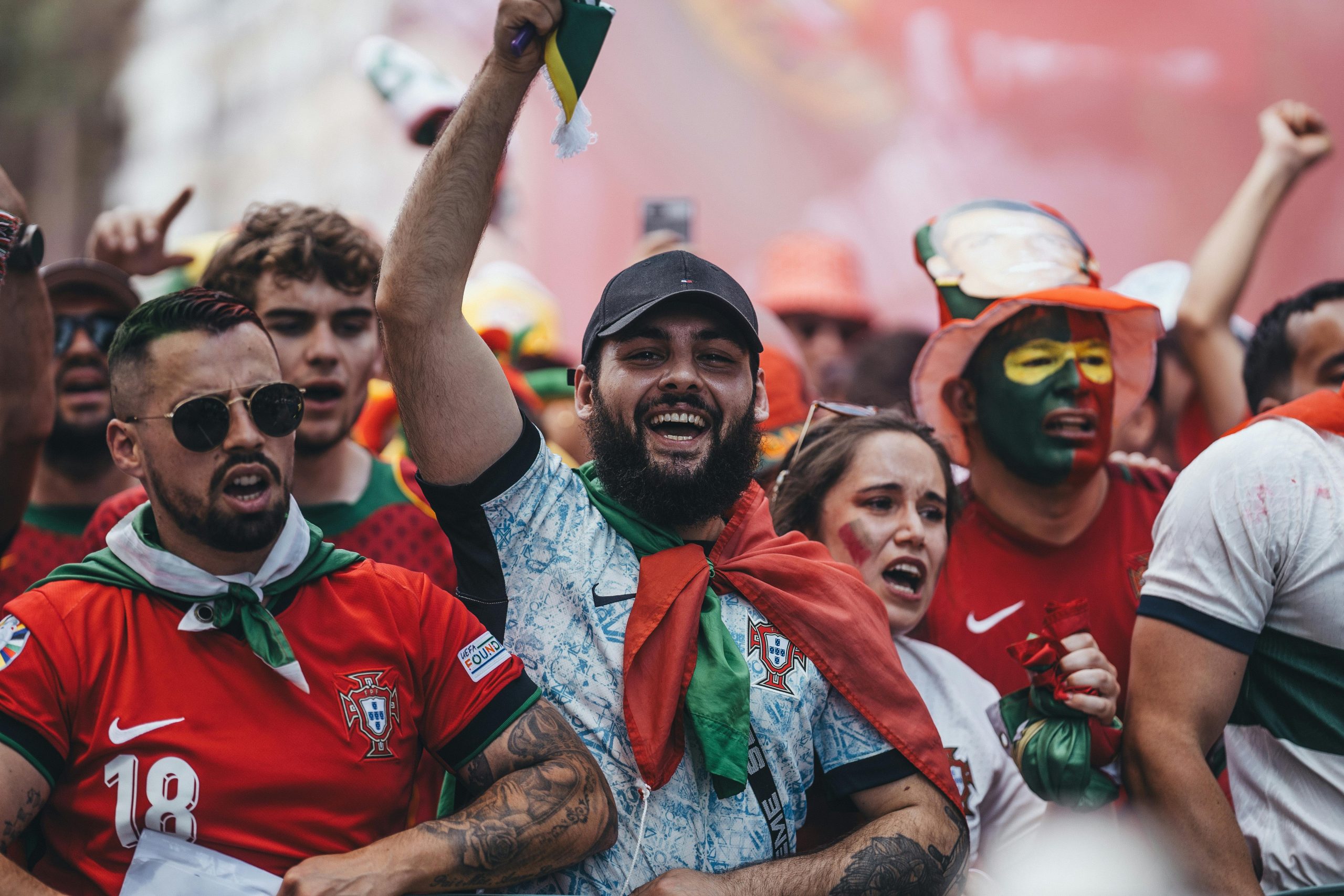 An image of enthusiastic sport fans cheering in a crowd.