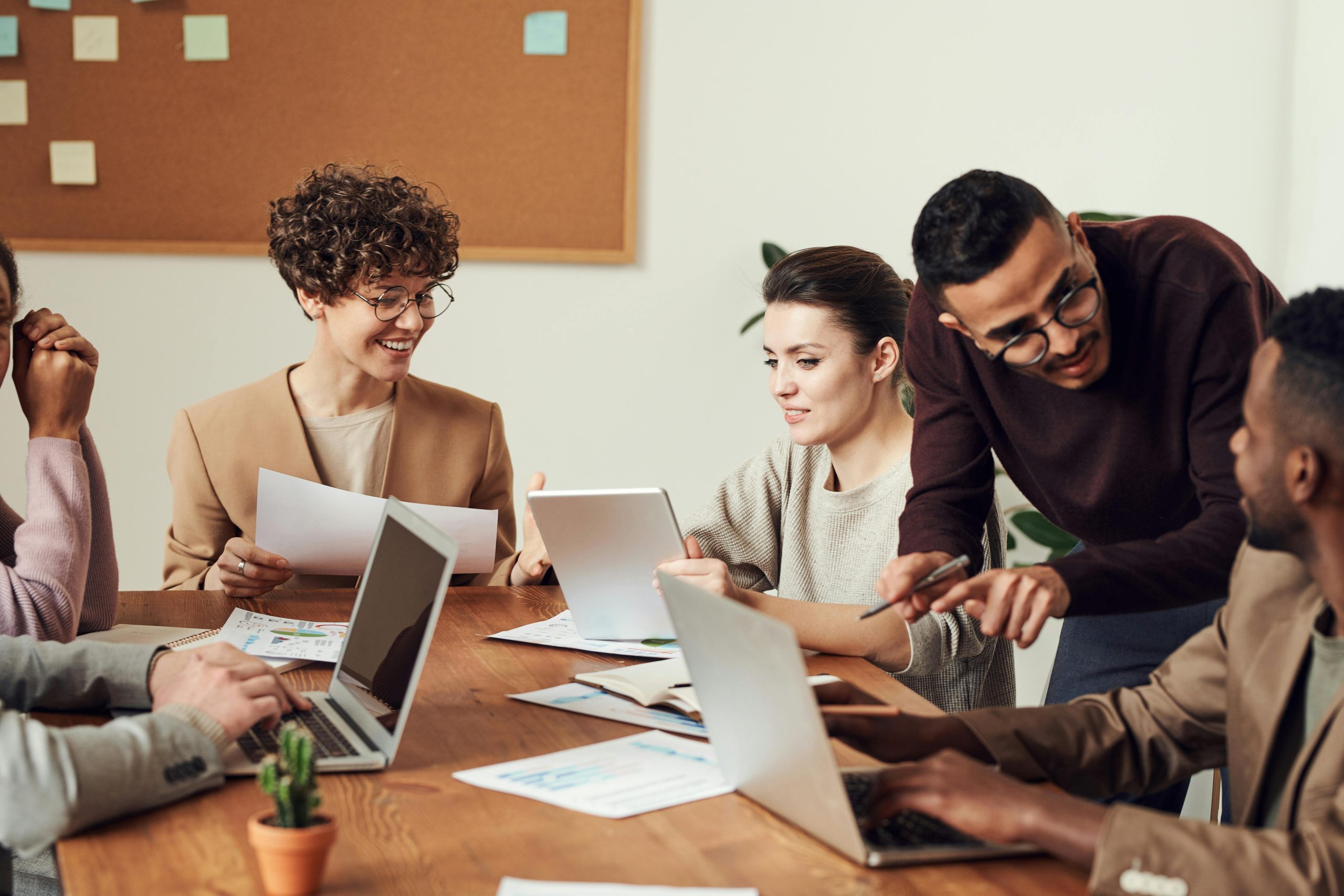 A group of people gather around a table sharing ideas.