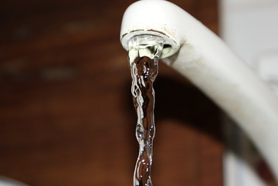 Photograph of water flowing from a tap.