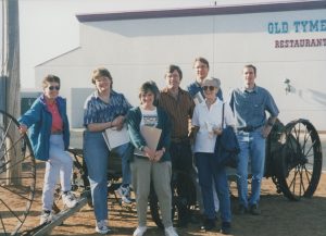 A group of people standing outside.