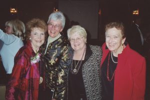 Four women smiling.