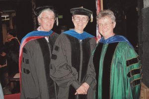 three women wearing graduation robes