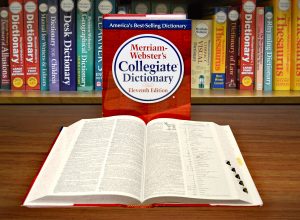 Collegiate Dictionary with open book and bookshelf.