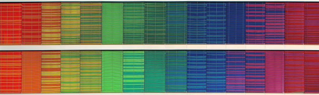 Rainbow, textured facade, mimicking the appearance of cloth books on a shelf