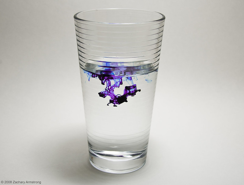 Diffusion shown by food coloring dropped into a glass of water