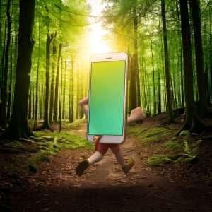 Image of a smart phone with feet running through a forest.