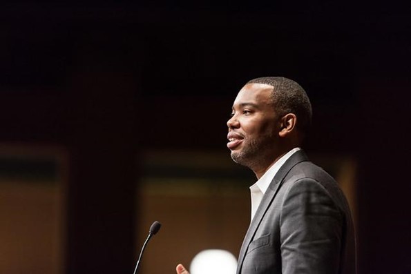 Ta-Nehisi Coates stands at a microphone.