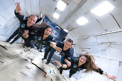 Photograph showing a group of people on a zero-gravity flight.