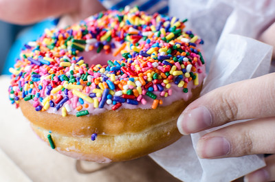 Photograph of sprinkles on a strawberry donut presented as a model for otoliths in the macula.