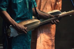 Image of a person playing a ngoni.
