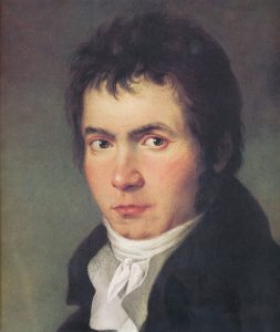 Portrait of a young man with dark hair in a formal black coat and white cravat.