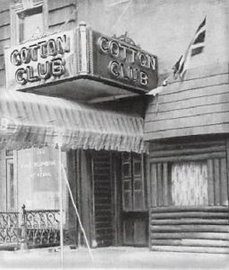 Exterior view of a historic building with "Cotton Club" signage.
