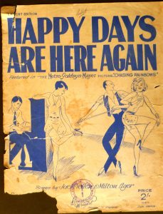 Vintage music cover with dancers and a pianist, highlighting the song "Happy Days Are Here Again."
