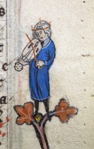 Medieval illustration of a musician in a blue robe, playing a vielle, standing on a decorative branch.