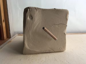 A large block of unsculpted pottery clay.